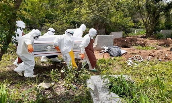 File photo: Environmental health officials on a mass burial of COVID-19 victims.