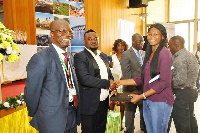 Mr. David Appiah, Public Relations Manager, Huawei Ghana (middle) presenting the award to Deborah