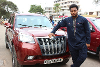 Kwadwo Safo Jr, CEO of Kantanka Automobile standing beside the company