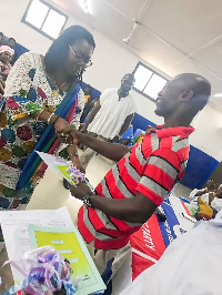 Ursula Owusu Ekuful handing over car documents to a constituent