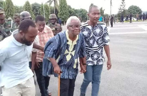 Leader of the group, Mr. Charles Kormi Kudzodzi being escorted