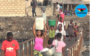 Residents cross a bridge before they can access potable water