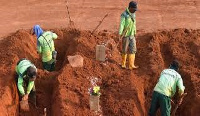 Some offenders of COVID-19 protocols made to dig graves in a public cemetery in Indonesia