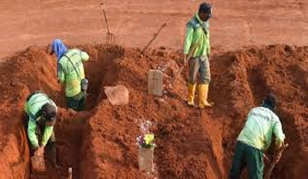 Some offenders of COVID-19 protocols made to dig graves in a public cemetery in Indonesia