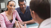 A photo of a couple consulting a medical practitioner