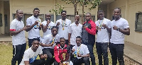 Mr Slater-Commodore (standing, fourth right) with the fighters and their medals and trophy