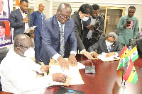 Ken Ofori-Atta (left) and Mr Selver Kumar signing the documents