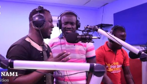 Some staff of Zylofon FM singing praises to God in the studio after NAM1's release