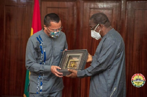 Mr Gregory Andrews (L) making a presentation to Speaker Alban Bagbin