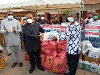 Alex Segbefia (left) presenting the items to Godfred Ofoe Caesar