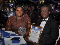 Ms. Jackie Senoo together with Mr. Prosper Gati display the award