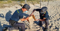 Police officers return sand to di famed Sardinia beach for Italy