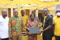 CEO MTN Selorm Adadevoh (2nd Lft) presents Laptops to Officials of Asokwa MA Basic School