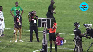 Referee Redouane Jiyed checking the VAR