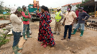 Ga East MCE, Janet Tulasi Mensah inspecting work progress on the culvert