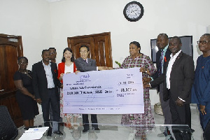 Chinese Ambassador to Ghana, H.E. Shi Ting Wang making the donation to First Lady Rebecca Akufo-Addo