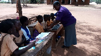 Avorvi D /A Primary School pupils study under trees