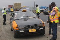 Police Motor Traffic and Transport Department officers on the street checking driver's license