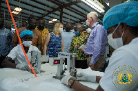 The president speaks to some managers of the facility during his visit