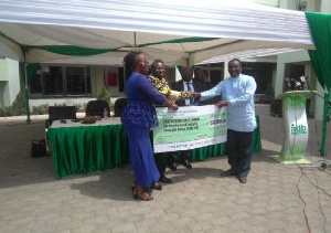 Charles Gyamfi (left), 2019 National Best Farmer receives his cash prize