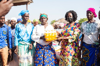 Professor Naana Opoku-Agyemang donating to old women