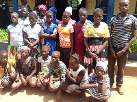 19 trafficked girls and their trafficker, Jato Jonas (standing-right)