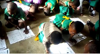 Pupils sit and lie on the floor to write and learn