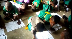 Pupils sit and lie on the floor to write and learn