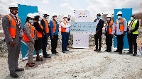 Officials at the bank presenting the cheque