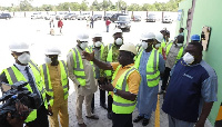 Officials inspecting the plant with the Minister