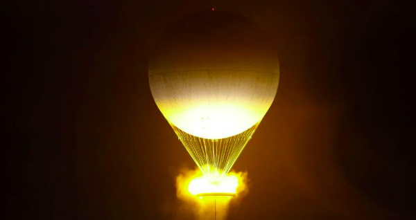 The Olympic flame was a cauldron shaped like a hot air balloon that rose high above the Parisian sky