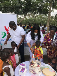 Afia Akoto cuts cake with the orphans during the donation