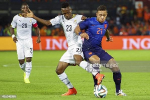 (L R) Kwadwo Asamoah, Harrison Afful And Memphis Depay Of Holland During During A Friendly Match