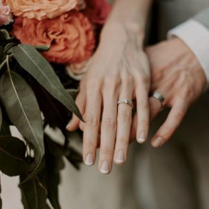 Two Hands With Silver Wedding Bands 