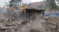 The bulldozer pulling own structures at the premises