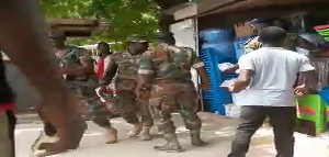 Some military personnel captured with crumpled placards