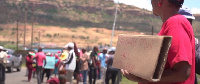 A protester hold a paper card