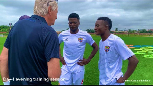 Rene Hiddink interacting with some players of Hearts of Oak at Pobiman