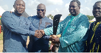 Ali Lukeman (second right) receiving the sword of honour from his predecessor