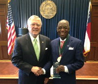 Dr. Mensah (right) with the NAI Plaque congratulated by Governor Deal of Georgia