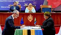 Tanzania President Samia Suluhu Hassan (centre) with Finance Minister Mwigulu L. Nchemba witness the