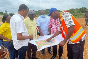 Mr Owusu-Bio (second from left) interacting with other members of the Committee and workers