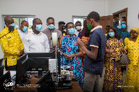 Ursula Owusu-Ekuful interacting with a student during the unveiling of ICT library and robotics lab