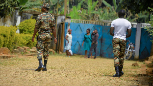 Soldiers patrol in Bafut, after the roof of a school's dormitory was set to fire overnight