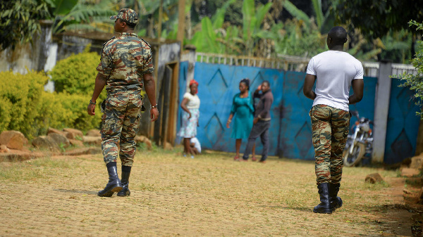 Soldiers patrol in Bafut, after the roof of a school's dormitory was set to fire overnight