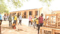 81 dual desks delivered to Naaga Basic School through the instrumentality of Desmond [in wine shirt]