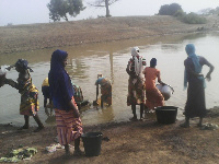 File photo of people fetching water from a stream due to shortage of water.