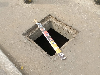 A gaping hole in the middle of the road