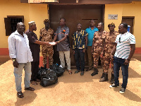 Hajia Zuwera Ibrahimah presenting the items to the Municipal Prisons Commander