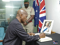 Stephen Ntim signing the book of condolence